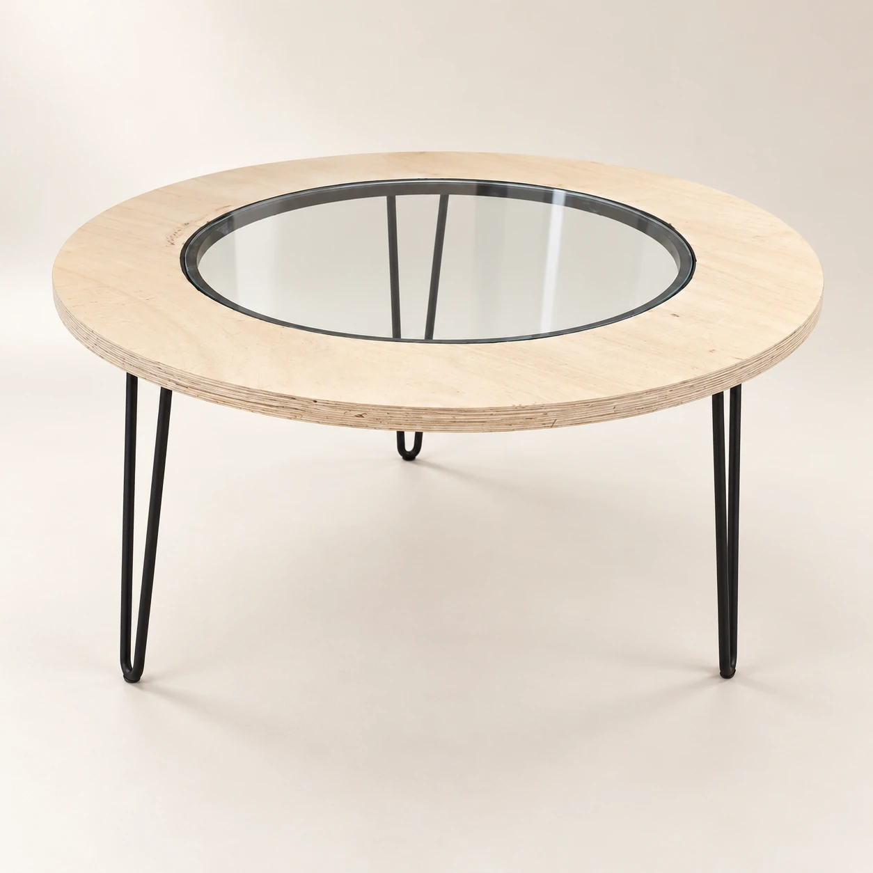 Sbhakabhaka — Pale plywood ring table with glass center
